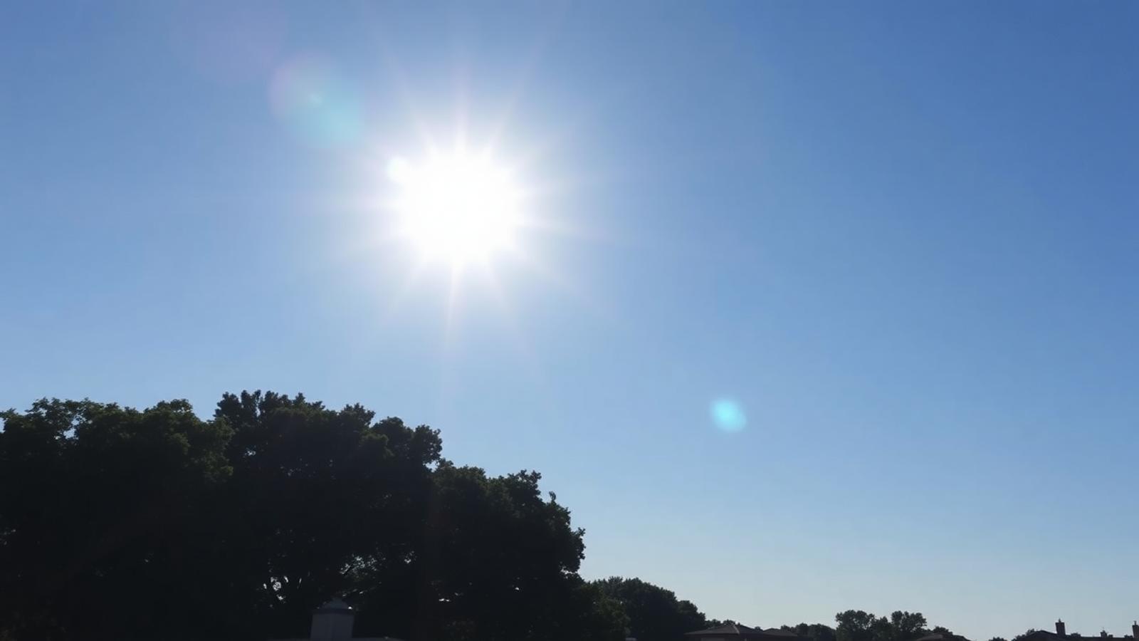 Blazing summer sun in a clear Central Texas sky above Austin rooftops and tree line