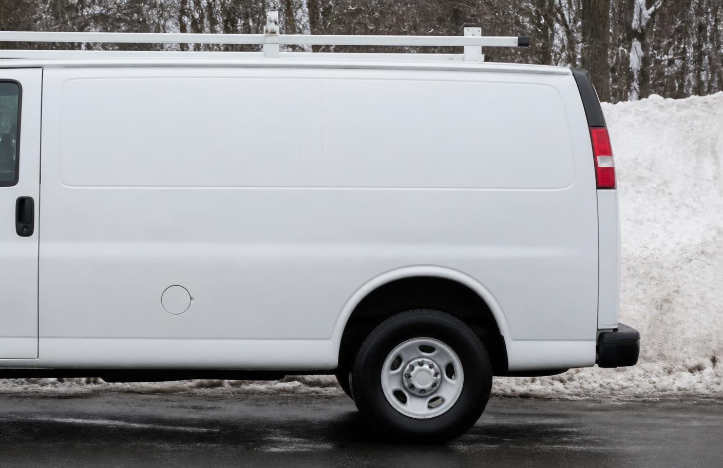 Contractor's service van parked on a snow-lined Erie street in winter