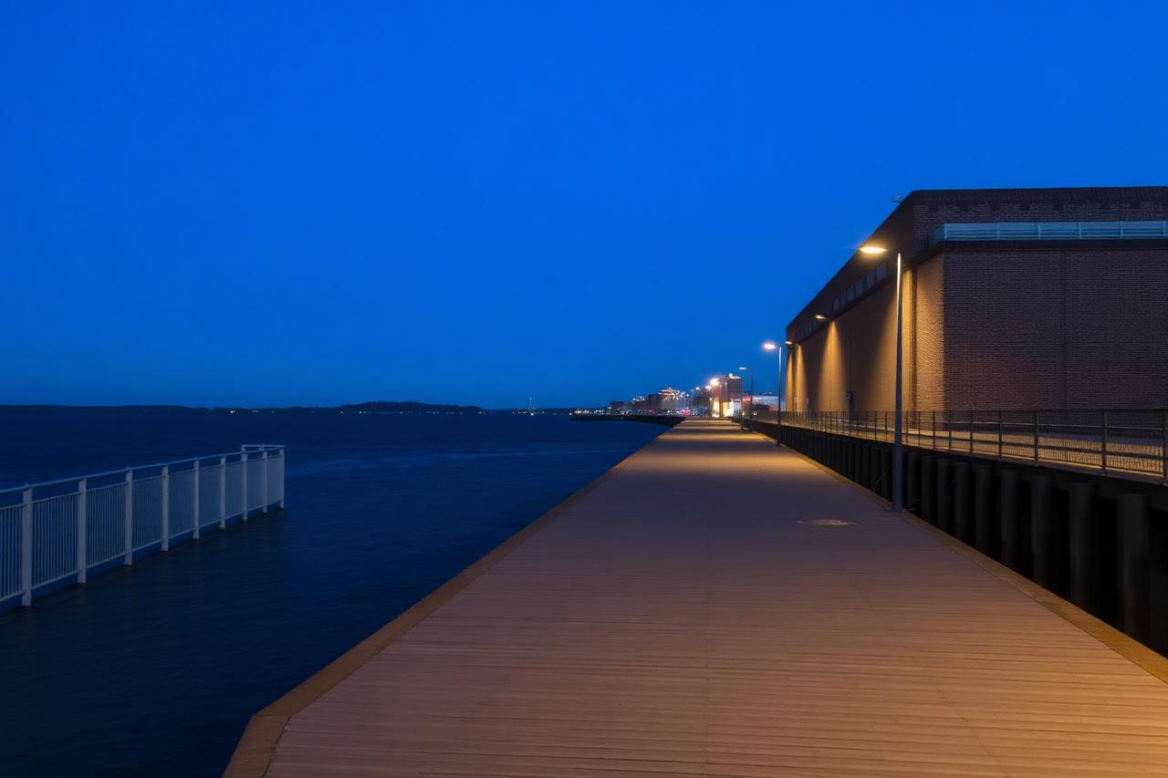 Empty boardwalk along the Oakland estuary waterfront at blue hour