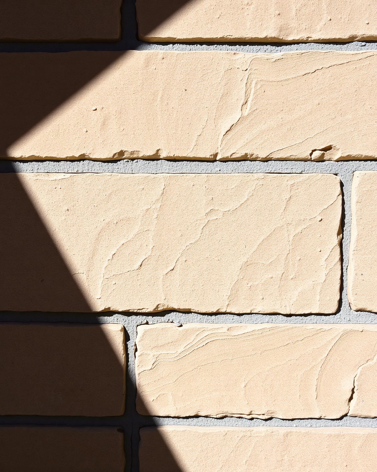 Close-up of limestone block and mortar wall texture on an Austin, Texas home in bright sunlight
