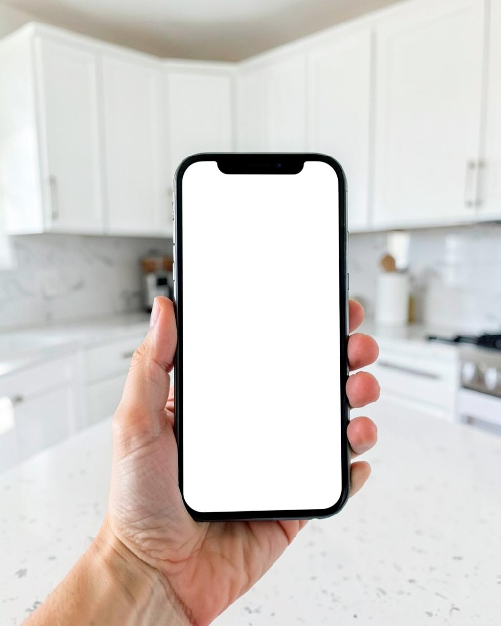 Hand holding a phone with a blank screen while standing in a new subdivision backyard with fresh landscaping