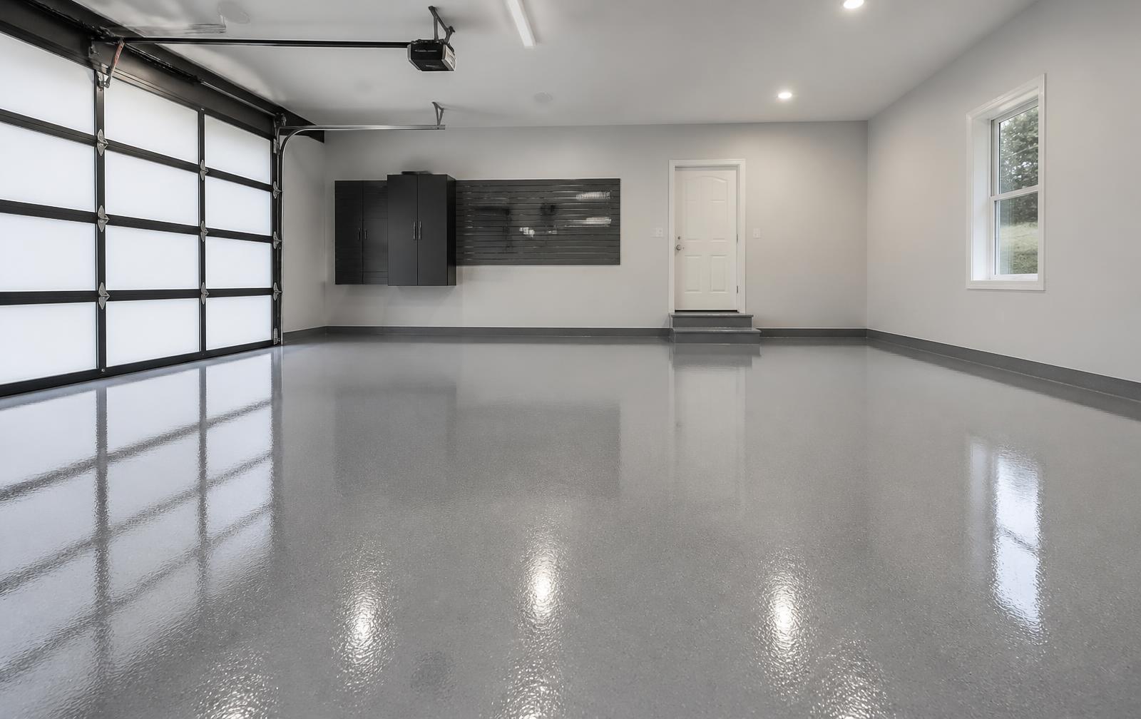 Wet-look glossy gray epoxy coating cured on a two-car garage floor in St. Petersburg
