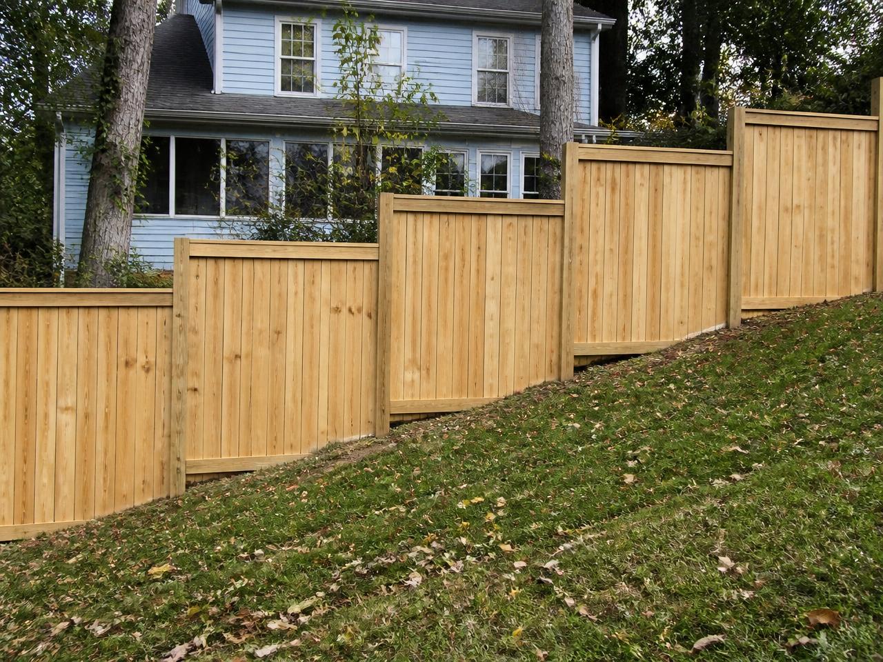 Stepped fence installed on a sloped Pittsburgh hillside yard