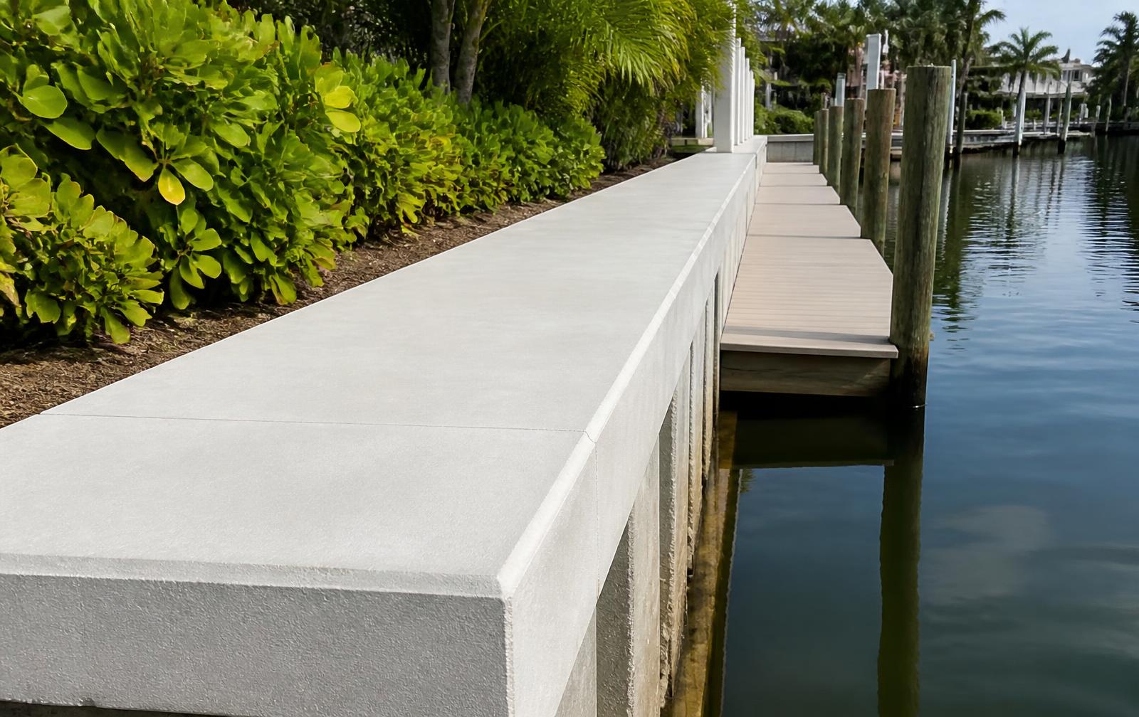Freshly poured concrete seawall cap running along a residential canal lot in St. Petersburg